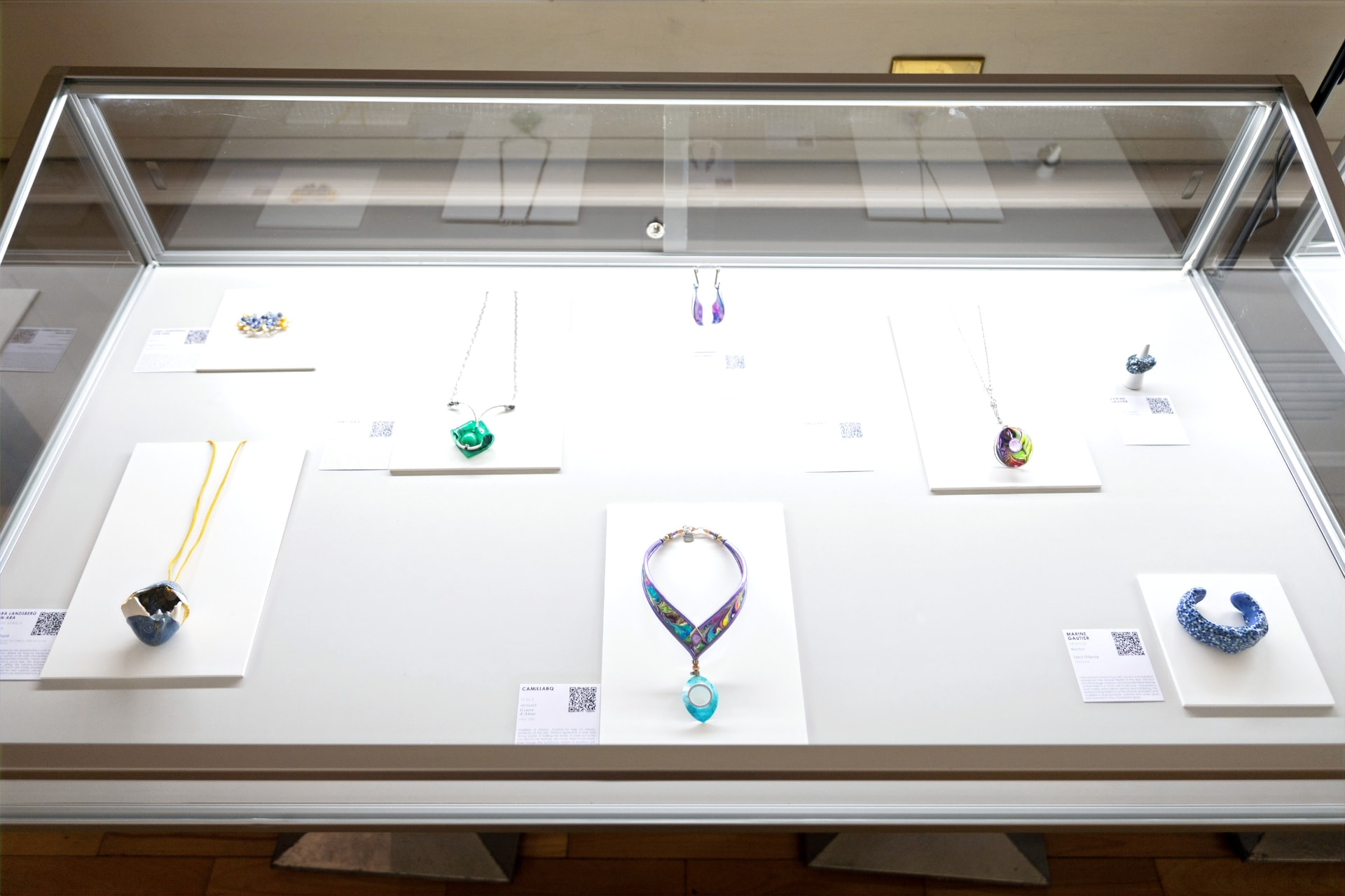 VON ARA porcelain pieces displayed in a lit vitrine at Palazzo Bovara, Milan.