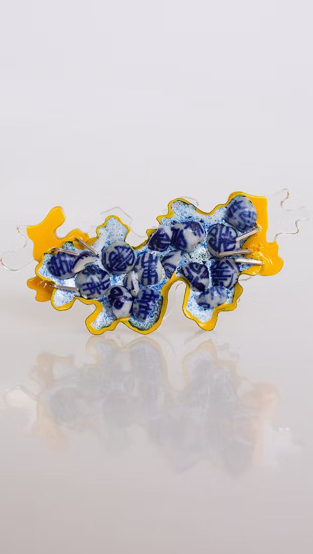 Fragmentation (2021) — crushed porcelain beads, enamel, copper, sterling silver and Perspex brooch.