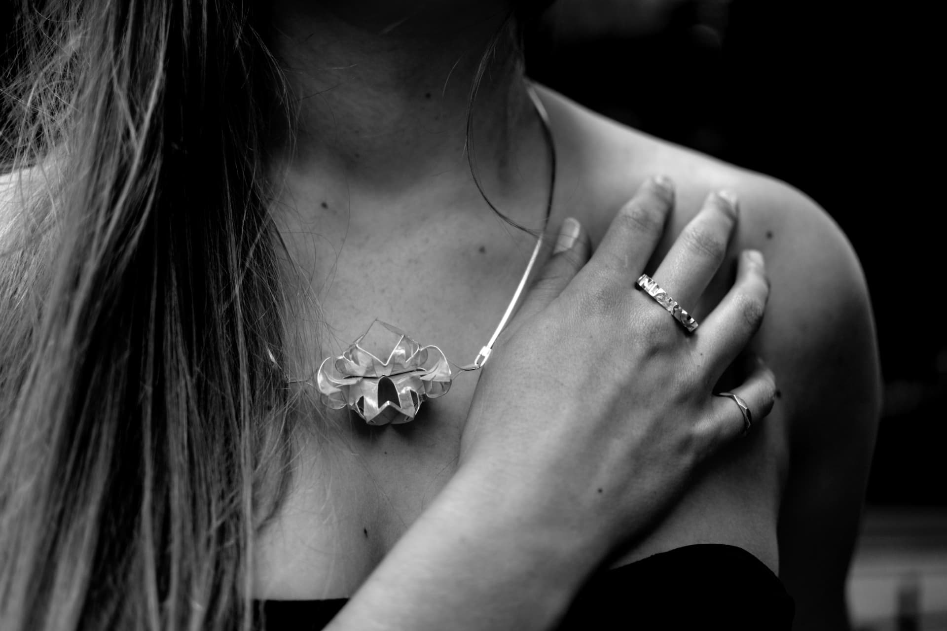 Handmade folded sterling silver neckpiece and rings by VON ARA, worn