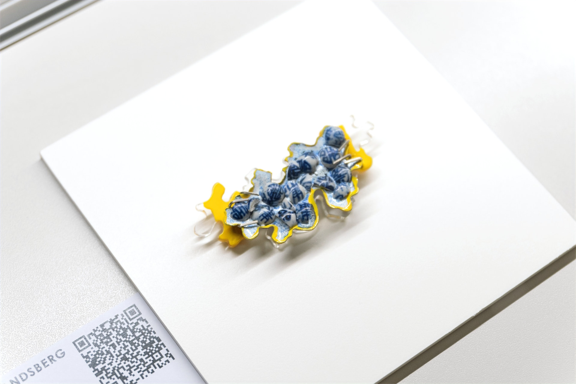 Fragmentation (2021) — crushed porcelain beads set against polished Perspex. Milano Jewellery Week 2023.