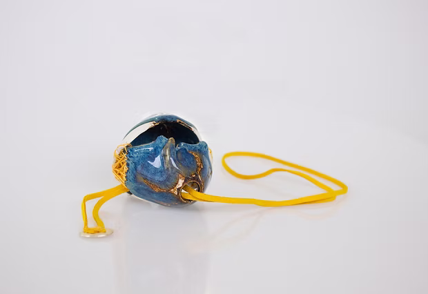 Shallow Depth (2021) — a glazed porcelain vessel reworked into a wearable piece.